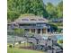 Exterior view of a grand clubhouse overlooking a pool and playground at 110 Cramer Mountain Woods None, Cramerton, NC 28032