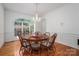 Traditional dining room with hardwood floors, chandelier, wainscoting, and large window at 110 Cramer Mountain Woods None, Cramerton, NC 28032