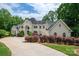 Stately home with manicured landscaping, a circular driveway, and a grand entrance framed by elegant columns at 110 Cramer Mountain Woods None, Cramerton, NC 28032