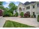 Attractive home featuring elegant columns, manicured landscaping, and a spacious circular driveway at 110 Cramer Mountain Woods None, Cramerton, NC 28032