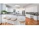 Bright, open kitchen features granite countertops, white cabinets, and a breakfast bar at 110 Cramer Mountain Woods None, Cramerton, NC 28032