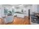 Bright kitchen with granite countertops, white cabinets, and an island cooktop at 110 Cramer Mountain Woods None, Cramerton, NC 28032