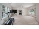 Spacious living room featuring neutral carpet, a large window, and exercise equipment at 110 Cramer Mountain Woods None, Cramerton, NC 28032