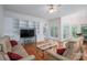 Spacious living room with hardwood floors, built-in shelving, and French doors to the back at 110 Cramer Mountain Woods None, Cramerton, NC 28032