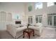 Bright and open living room featuring a fireplace, built-in shelving, and French doors at 110 Cramer Mountain Woods None, Cramerton, NC 28032