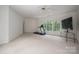 Bright living room with large windows offering wooded views and exercise equipment at 110 Cramer Mountain Woods None, Cramerton, NC 28032