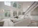 Bright living room with large windows, French doors, a staircase, and plush seating at 110 Cramer Mountain Woods None, Cramerton, NC 28032