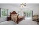 Comfortable main bedroom features a large window, exterior door, and a decorative ceiling fan at 110 Cramer Mountain Woods None, Cramerton, NC 28032