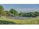 View of a large tennis court area with the clubhouse in the background at 110 Cramer Mountain Woods None, Cramerton, NC 28032