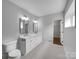 Bright bathroom featuring dual sinks, a toilet, and a door to a walk in closet at 141 Edenvale Rd, Rock Hill, SC 29730