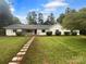 Charming, single-story home with a well-manicured lawn and inviting walkway at 141 Edenvale Rd, Rock Hill, SC 29730