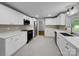 Modern kitchen featuring white cabinetry, stainless steel appliances, and elegant quartz countertops at 141 Edenvale Rd, Rock Hill, SC 29730