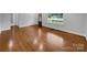 Spacious room featuring gleaming hardwood floors, neutral tones, and natural light from the windows at 141 Edenvale Rd, Rock Hill, SC 29730