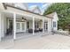 Covered back porch features ceiling fans, patio furniture, and a jacuzzi tub overlooking the yard at 14807 Middlesborough Dr, Matthews, NC 28104