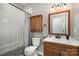 Well-lit bathroom with a modern vanity, shower with white subway tile and tub at 14807 Middlesborough Dr, Matthews, NC 28104