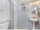Bathroom featuring a stand-up shower with glass doors and a pedestal sink at 14807 Middlesborough Dr, Matthews, NC 28104