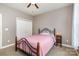 Bright bedroom with a ceiling fan, closet, and carpet, creating a comfortable space at 14807 Middlesborough Dr, Matthews, NC 28104