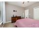 Comfortable bedroom with ceiling fan, dresser, carpeted floors, and natural light at 14807 Middlesborough Dr, Matthews, NC 28104