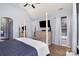 Bright bedroom featuring a four-poster bed, wood floors, and modern furniture at 14807 Middlesborough Dr, Matthews, NC 28104