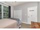 Inviting bedroom featuring a large window, ample closet space, and cozy carpet at 14807 Middlesborough Dr, Matthews, NC 28104