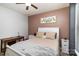 Comfortable bedroom featuring a cozy bed, natural light, and stylish decor at 14807 Middlesborough Dr, Matthews, NC 28104