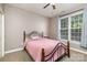 Cozy bedroom featuring a ceiling fan and a large window with natural light at 14807 Middlesborough Dr, Matthews, NC 28104