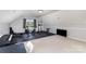 The bonus room is equipped with exercise equipment and black padded floors under a vaulted ceiling at 14807 Middlesborough Dr, Matthews, NC 28104