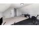 Spacious bonus room or flex space with a piano and exercise equipment at 14807 Middlesborough Dr, Matthews, NC 28104