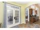 Inviting entryway with French doors leading to the deck and archway to the dining room at 14807 Middlesborough Dr, Matthews, NC 28104