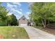 Charming brick and siding home with a long driveway and lush green lawn at 14807 Middlesborough Dr, Matthews, NC 28104