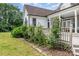 Charming home exterior with a spacious porch and beautifully landscaped garden at 14807 Middlesborough Dr, Matthews, NC 28104