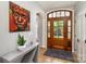 Entryway boasting a hardwood floor, stylish console table, and solid wood front door with glass panels at 14807 Middlesborough Dr, Matthews, NC 28104