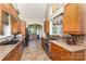 Spacious kitchen featuring stainless steel appliances, tile floors, and beautiful wooden cabinetry at 14807 Middlesborough Dr, Matthews, NC 28104