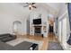 Open living room with vaulted ceilings, fireplace, and built-in shelving, offering a spacious layout at 14807 Middlesborough Dr, Matthews, NC 28104