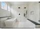 A modern bathroom with a soaking tub, walk-in shower, and black hardware at 149 Shady Cove Rd, Troutman, NC 28166
