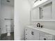 Contemporary bathroom with a white vanity, black fixtures, and a toilet with stylish finishes at 149 Shady Cove Rd, Troutman, NC 28166