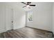 Bright bedroom with laminate flooring, neutral paint, a ceiling fan, and window at 149 Shady Cove Rd, Troutman, NC 28166