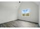 Bedroom with vaulted ceiling, neutral paint, laminate flooring and large window at 149 Shady Cove Rd, Troutman, NC 28166