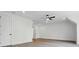 An airy bonus room features vinyl floors, a ceiling fan, and bright modern lighting at 149 Shady Cove Rd, Troutman, NC 28166