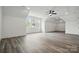 Spacious bonus room featuring wood flooring, modern lighting, and ample natural light at 149 Shady Cove Rd, Troutman, NC 28166