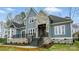 Beautiful exterior featuring stone accents, a covered porch, and a lovely landscaped yard at 149 Shady Cove Rd, Troutman, NC 28166