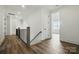 Hallway with hardwood floors, wood and iron handrail and staircase, leading to another room at 149 Shady Cove Rd, Troutman, NC 28166