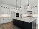 Spacious kitchen boasts shaker cabinets, stylish pendant lights, and a large center island with seating at 149 Shady Cove Rd, Troutman, NC 28166