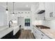 Modern kitchen features a farmhouse sink, stainless appliances, and contrasting counter tops and cabinetry at 149 Shady Cove Rd, Troutman, NC 28166