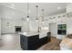 Open kitchen features island with sink, stainless appliances, and eat-in space that opens to the living area at 149 Shady Cove Rd, Troutman, NC 28166