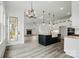 Stylish eat-in kitchen with black island sink and stainless appliances has a stone fireplace in the living area at 149 Shady Cove Rd, Troutman, NC 28166