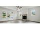 Cozy living room featuring a stone fireplace and large windows with natural light at 149 Shady Cove Rd, Troutman, NC 28166