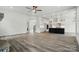 Open-plan living area with wood-look flooring, a black island, and an eat-in kitchen with stainless appliances at 149 Shady Cove Rd, Troutman, NC 28166