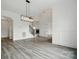 Open-concept living room with high ceilings and elegant lighting fixtures at 149 Shady Cove Rd, Troutman, NC 28166