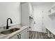 Mudroom with marbled counter, matte sink, cabinetry, and built-in bench seating at 149 Shady Cove Rd, Troutman, NC 28166